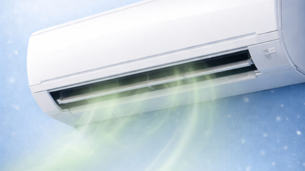 Wall-mounted air conditioner emitting airflow, representing common aircon smells like sour, musty, burnt, or fishy and their causes by Peakcool.