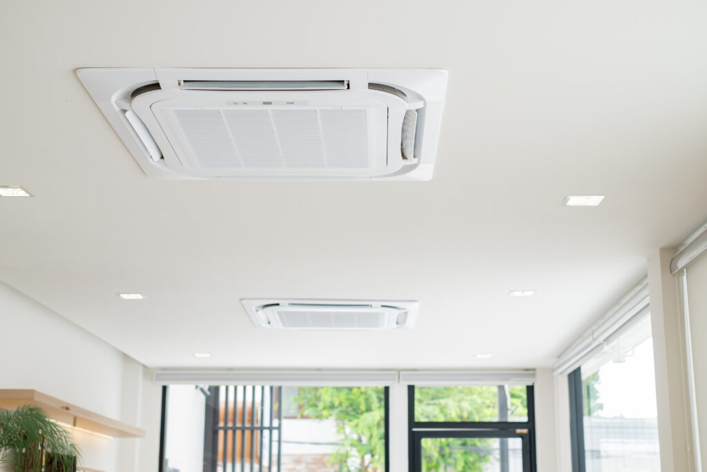 Ceiling-mounted cassette air conditioners installed in a modern space, illustrating commercial aircon installation for offices, retail shops, and corporate environments by Peakcool.